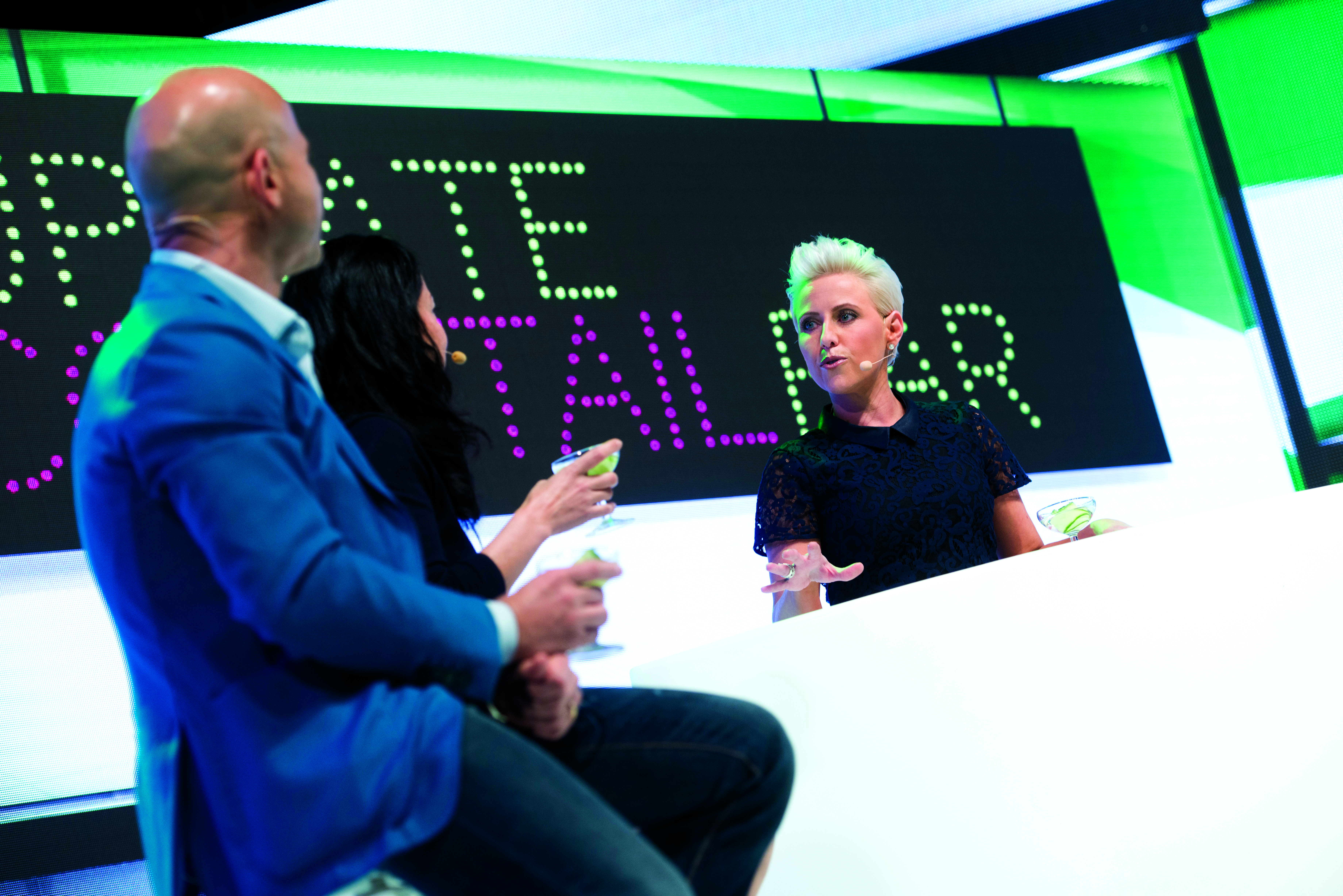 Laura "tending bar" as emcee after a heady conference day in Finland