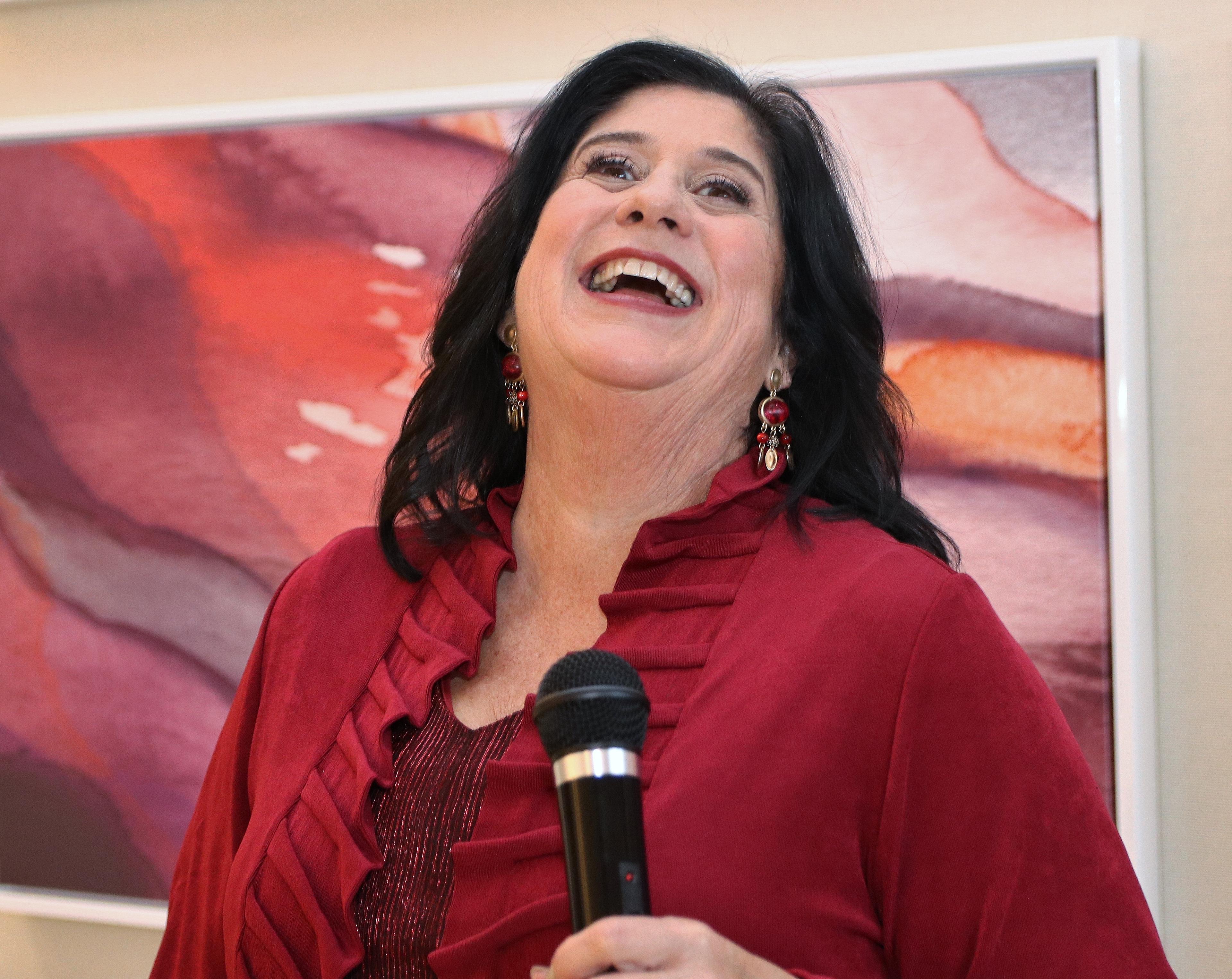 Arlene Gale Holding Mic and Laughing
