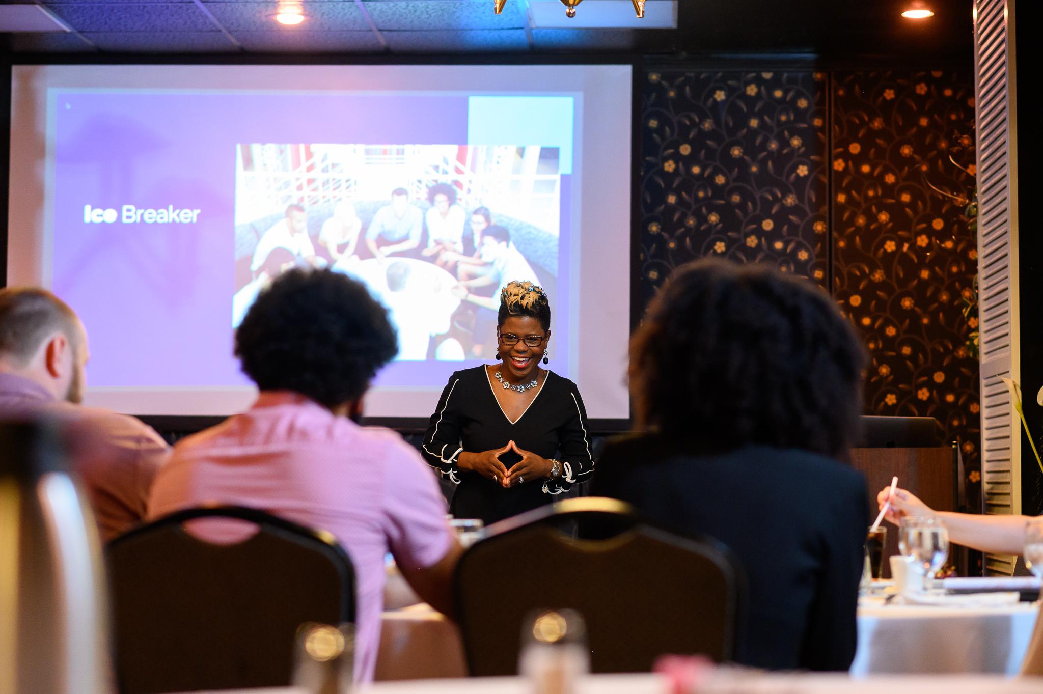 Tiffany Lewis | speaking w/hands in front | color photo