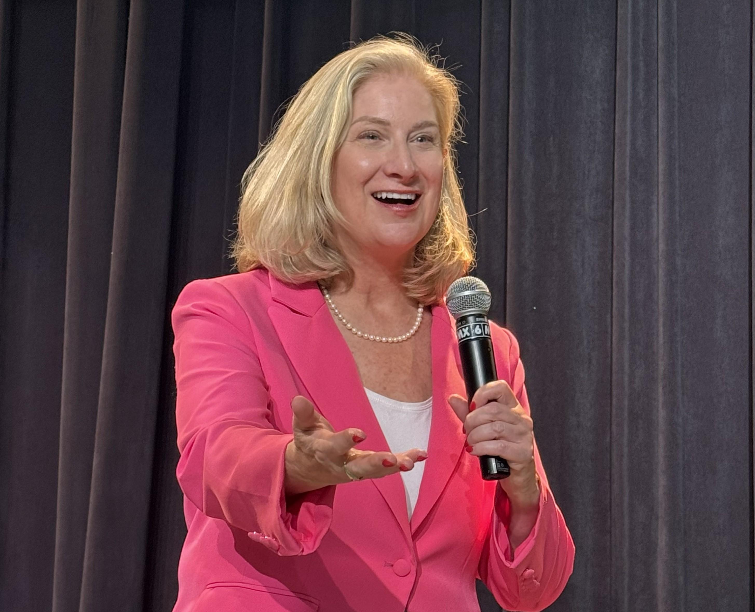 Lisa Conners on stage with mic